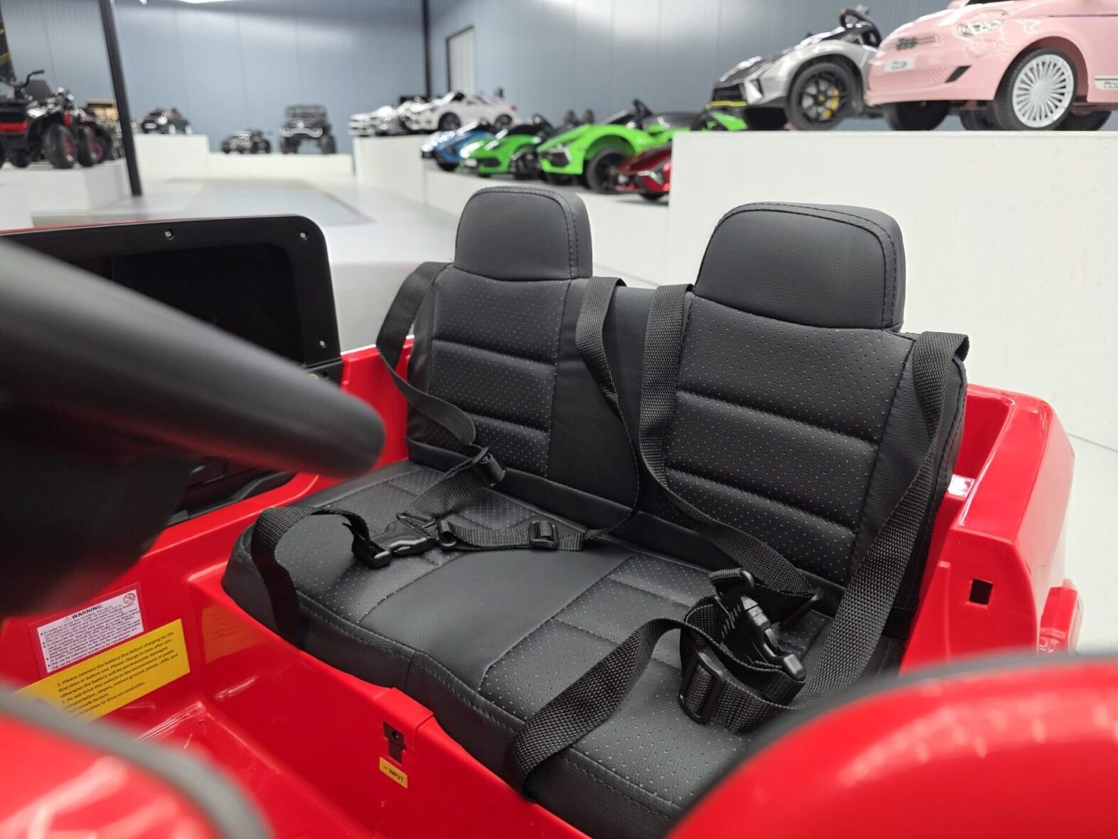 Dodge RAM 12V ride-on truck showing three-point safety seat belts