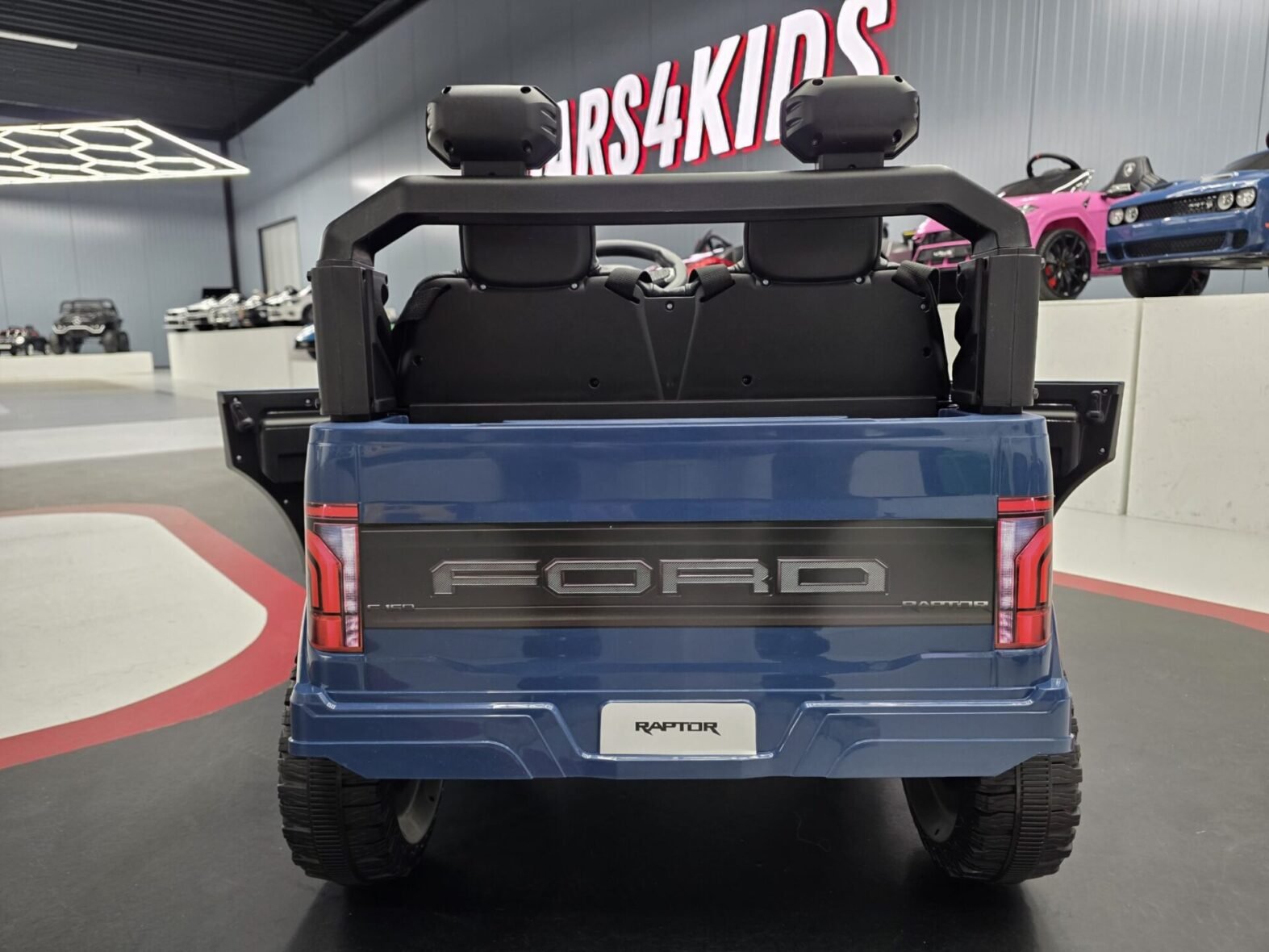 Ford Raptor 24V kids car side profile view in blue