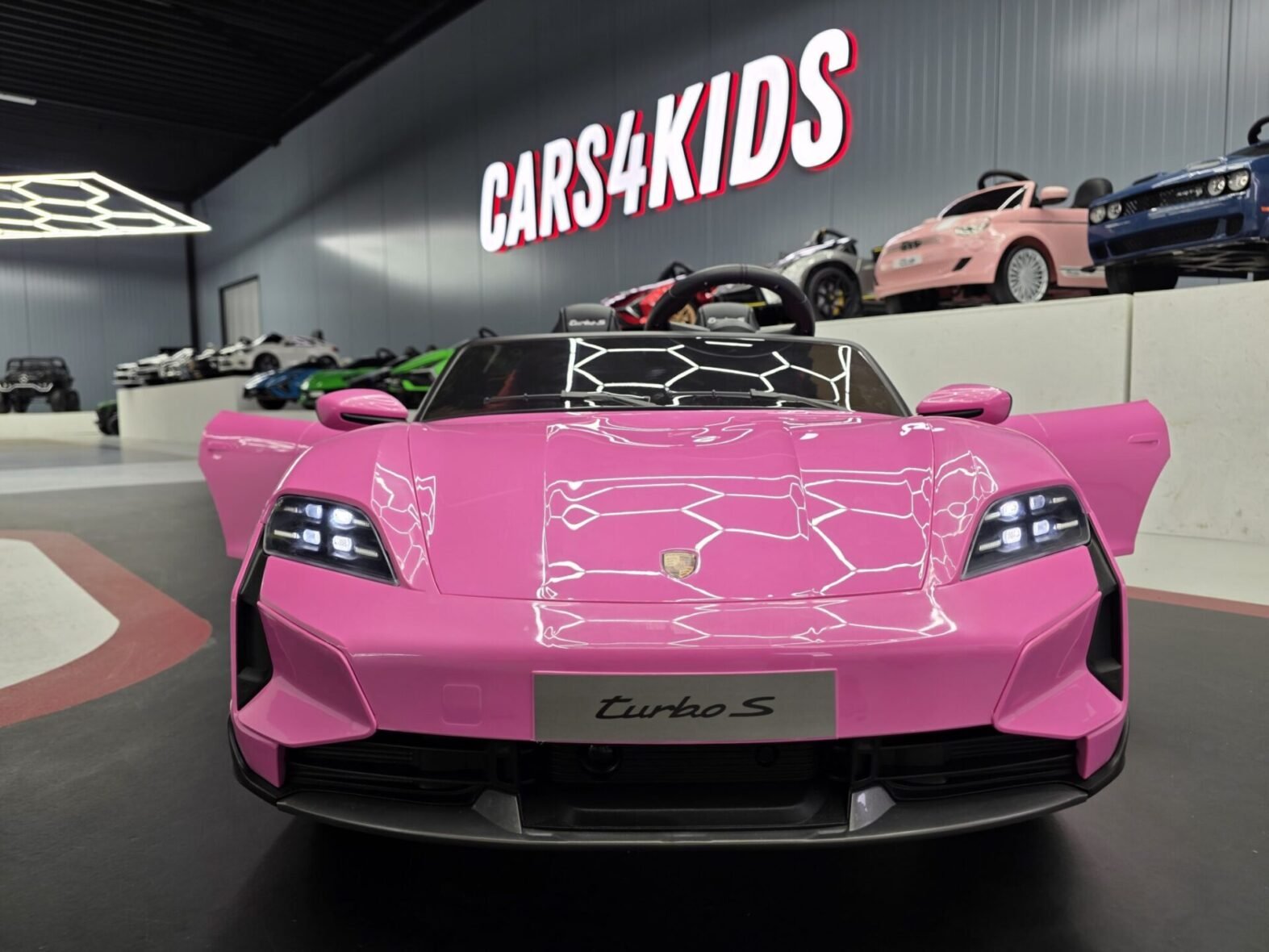 Porsche Taycan kids electric car pink side view with leather seats