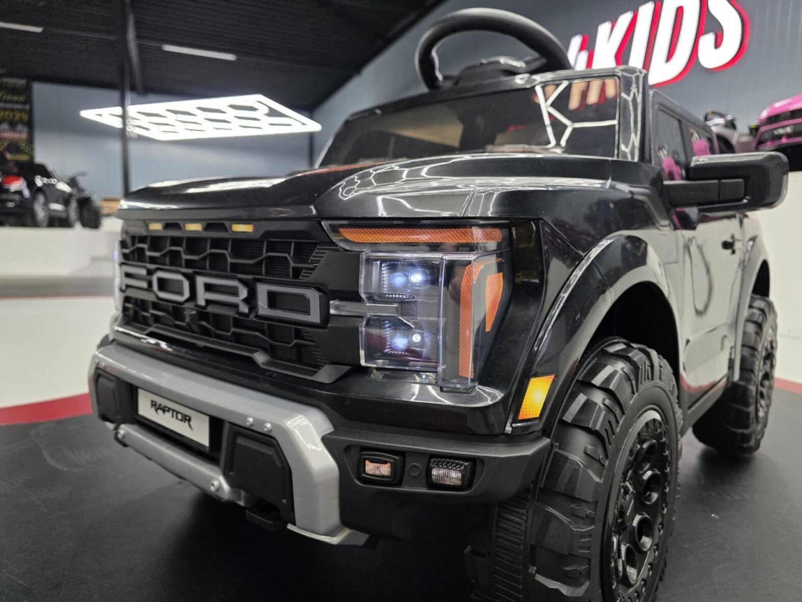 Ford Raptor kids car interior with seat belt and controls