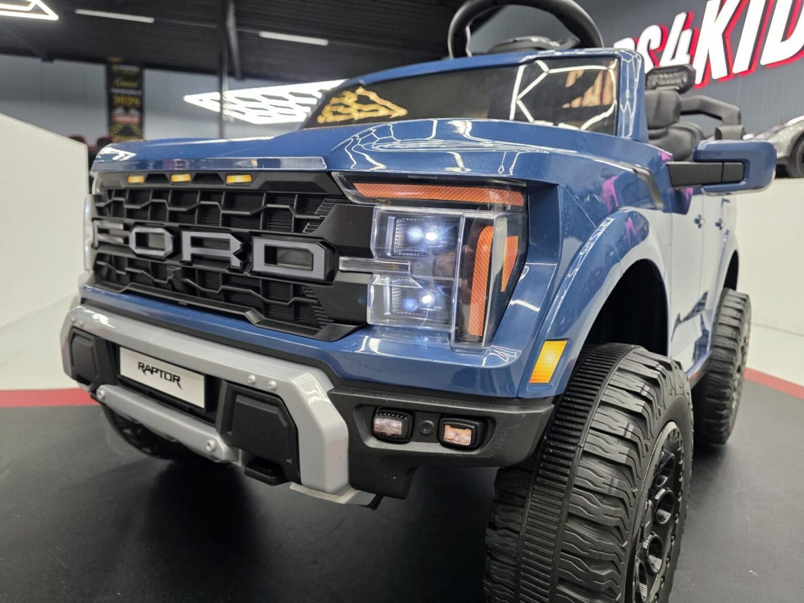 Ford Raptor electric ride-on car dashboard with radio and Bluetooth controls