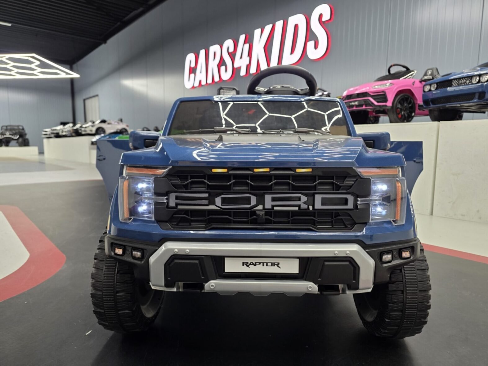 Ford Raptor kids electric car front view showing LED lights and grille