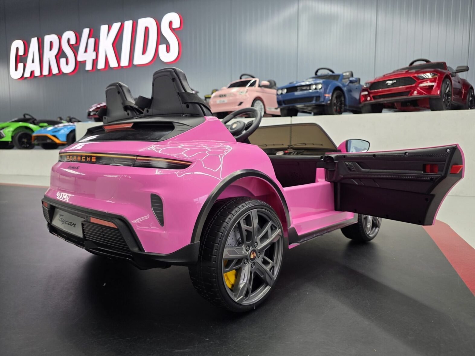 Pink Porsche Taycan kids car interior with leather seat and seat belts