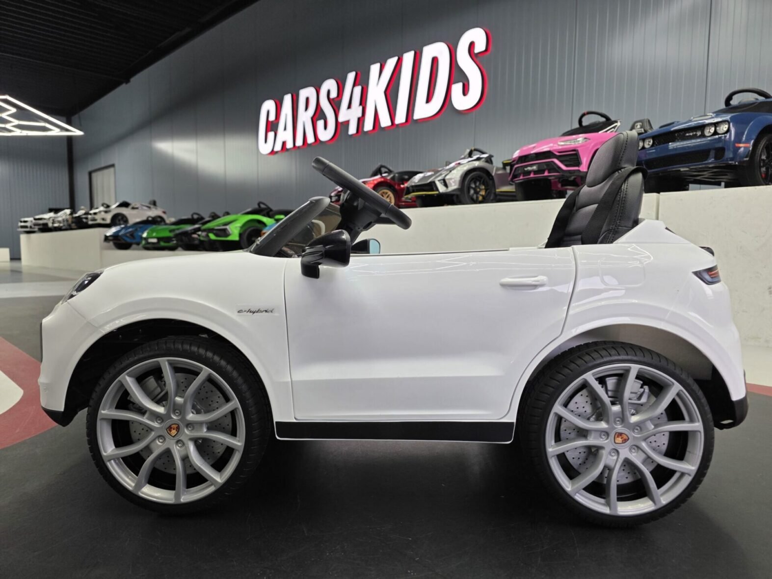Porsche Cayenne kids ride-on car interior showing leather seat and dashboard