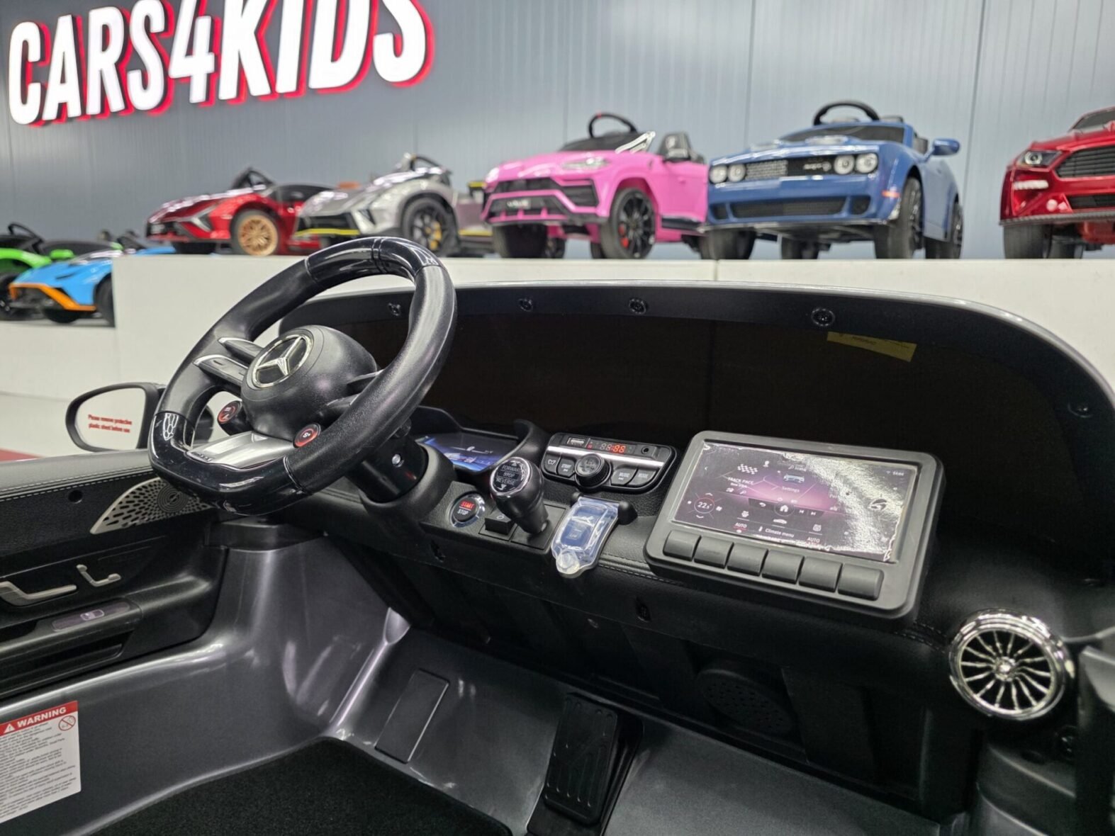 Two children riding in Mercedes GT63 electric car Ireland