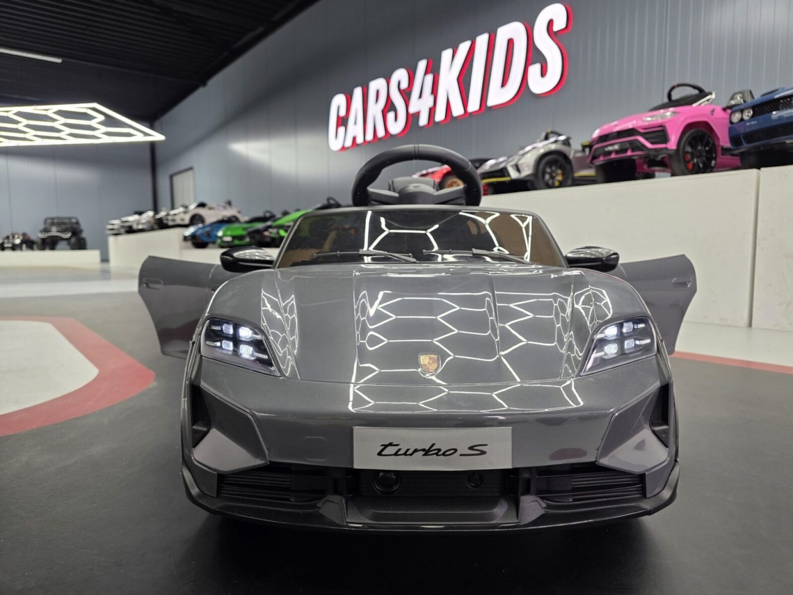 Grey Porsche Taycan electric car for kids front angle view