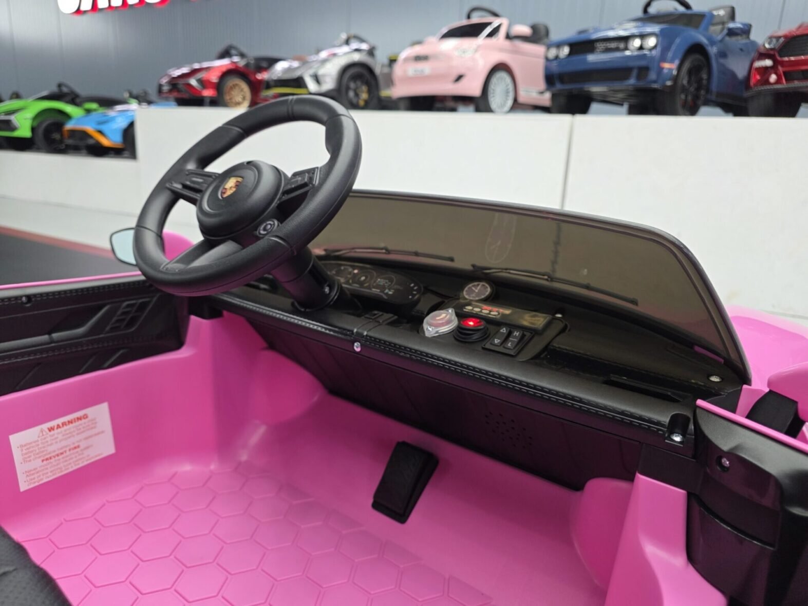 Two seater pink Porsche Taycan electric ride-on car full view