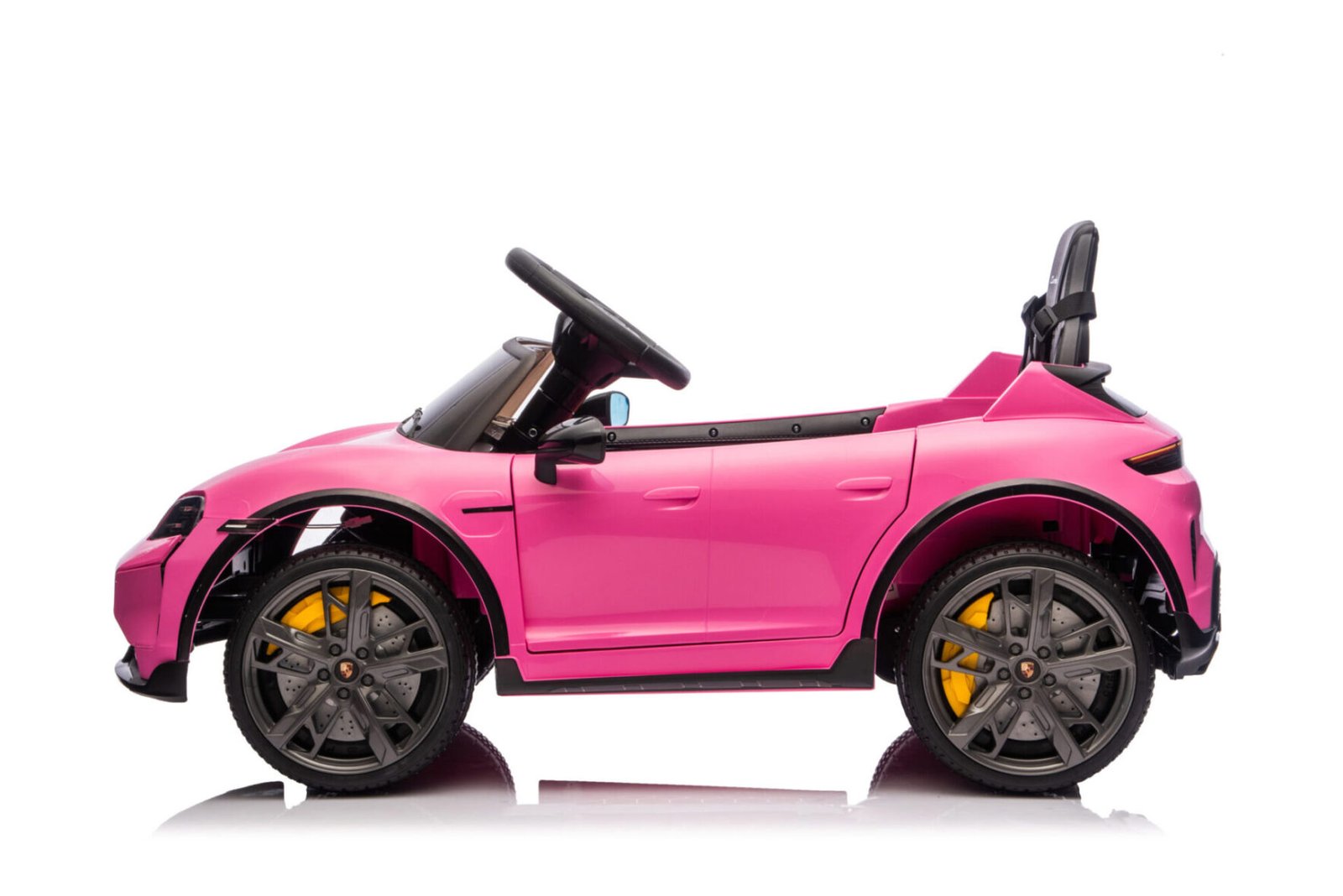 Pink Porsche Taycan children’s ride-on car side profile view
