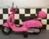 Pink Vespa electric scooter for children side view showing leather seat