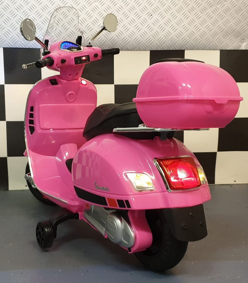 Kids pink Vespa scooter front view with working lights and windshield